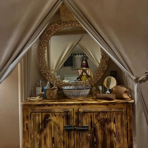 a woman taking a picture of herself in a bathroom mirror at Merzouga traditional Camp in Merzouga