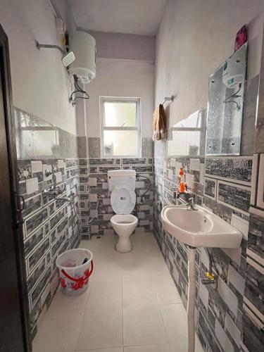 a bathroom with a toilet and a sink at Hams Cherrapunji in Cherrapunji