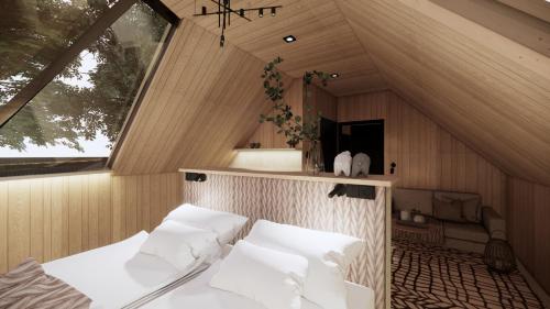 a room with a bed with white pillows at Vaattunki Wilderness Resort in Rovaniemi