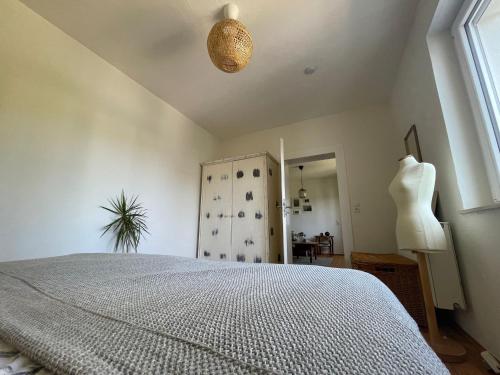 a bedroom with a bed and a dresser and a window at Ferienwohnung Utes Stube in Neuwied
