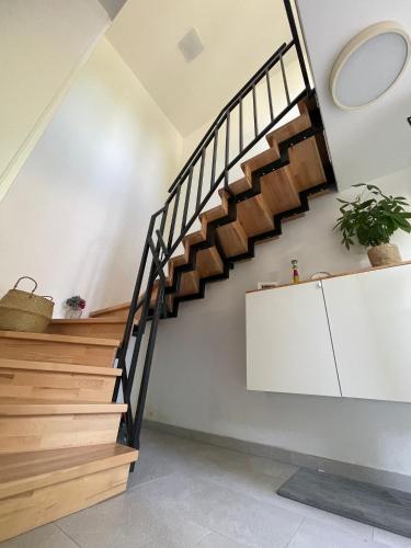 a staircase in a house with wooden stairs at Ferienwohnung Utes Stube in Neuwied