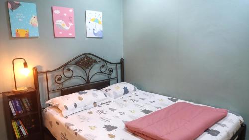 a bedroom with a bed with pillows on it at The Maple Homestay @ Kota Laksamana Melaka in Melaka