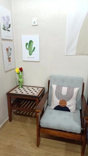 a living room with a chair and a table at The Maple Homestay @ Kota Laksamana Melaka in Melaka