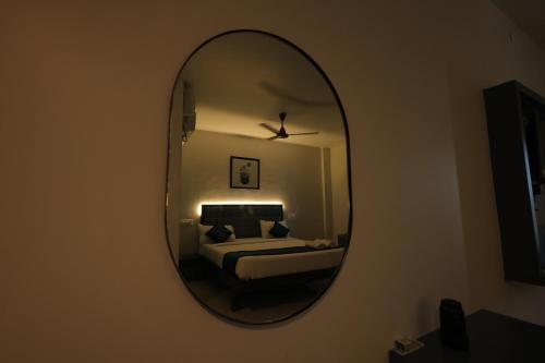 a mirror in a room with a bed and a bed sqor at The Lotus Park in Srikalahasti