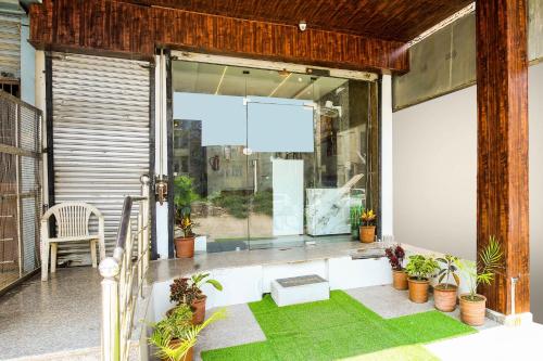 a balcony with a window and plants on it at Hotel O Zirakpur Bus Stand Formerly Hotel Umang in Zirakpur