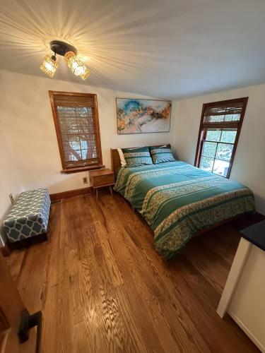 a bedroom with a large bed and a wooden floor at The Carraige House of Mount Vernon in Baltimore