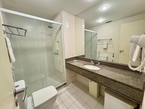 a bathroom with a sink and a shower and a toilet at H714- Congonhas Hotel Flat in São Paulo