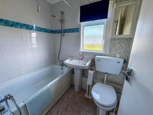 a bathroom with a sink and a toilet and a bath tub at Modern 4 Berth Chalet At California Sands Near Scratby Beach Ref 52064Cs in Scratby