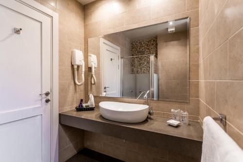 a bathroom with a sink and a mirror at Notre Dame of Jerusalem Center in Jerusalem