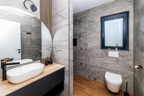 a bathroom with a white sink and a mirror at Villa Aria Prestige in Opatija