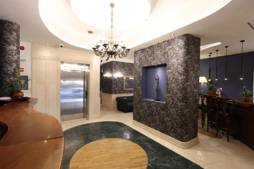 a large living room with a chandelier at Hotel Opera by Zeus International in Bucharest