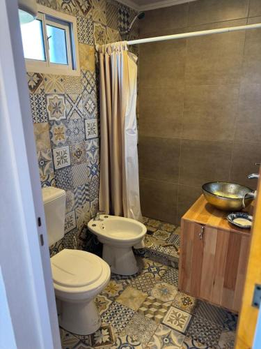 a bathroom with a toilet and a sink at Los Aromos in Federación