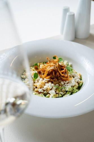 a white bowl of food with rice and meat at Sporthotel am Semmering in Semmering