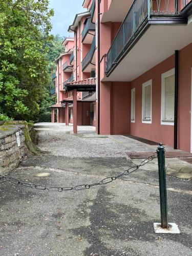 a building with a chain attached to a building at Sunset Lakeview Small Paradise in Stresa