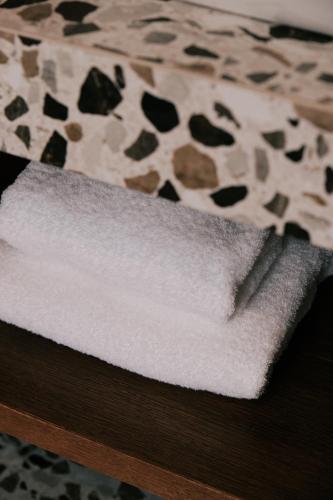 a pile of white towels sitting on top of a table at LOVIS Suites Vienna in Vienna