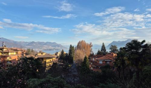 a view of a city with buildings and trees at Sunset Lakeview Small Paradise in Stresa
