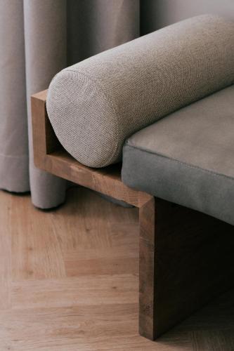 a couch sitting on top of a wooden bench at LOVIS Suites Vienna in Vienna