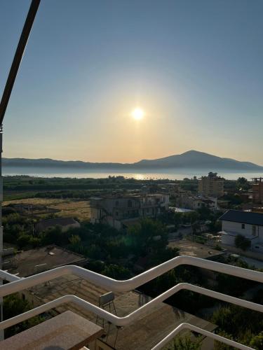 a view of the sun setting over a city at Orikum Apartment in Orikum