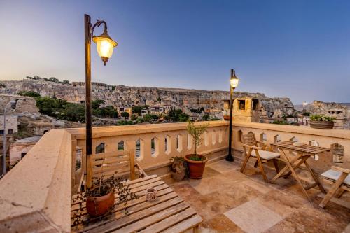 a balcony with a bench and a view of the city at Kayata Cave Suites Special Class in Urgup