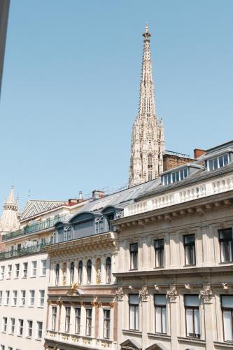 a view of a building with a tower in the background at LOVIS Suites Vienna in Vienna