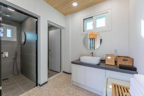 a bathroom with a sink and a shower at Gyeongju Bulguksa Family House Stay Mute in Gyeongju