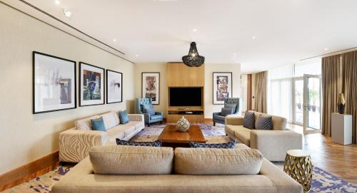 a living room with two couches and a tv at Radisson Blu Hotel & Convention Centre Kigali in Kigali