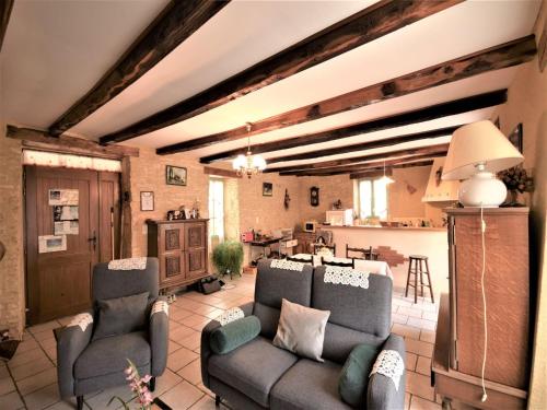 a living room with two couches and a kitchen at Peaceful Stay in Thédirac in Lavercantière