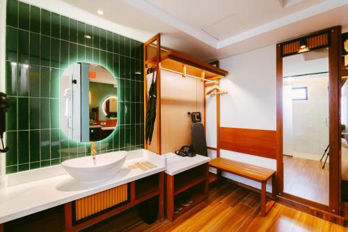 a bathroom with a sink and a mirror at Borneo Beach & Mangrove Resort in Tuaran