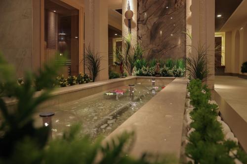 a lobby with a jacuzzi tub with plants at Ramada Plaza by Wyndham Mardin in Mardin