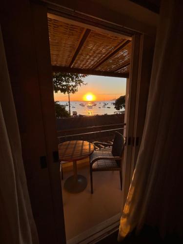 a view of the sunset from the balcony of a house at Pousada Corsario Buzios in Búzios
