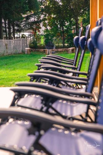 a row of empty seats in a park at Spa & Pool Table - Le Parvis in Trois-Pistoles