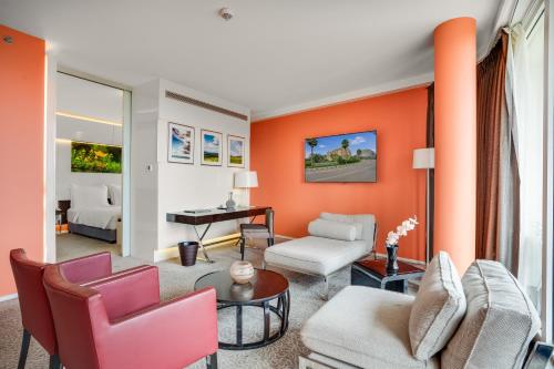 a living room with orange walls and furniture at Radisson Blu Hotel & Convention Centre Kigali in Kigali