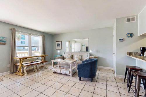 a living room with a couch and a table at North Lost Key Landing in Perdido Key
