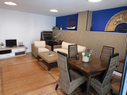 Una sala de estar con una mesa y sillas de madera. en Hotel O Noso Portosin, en Portosín