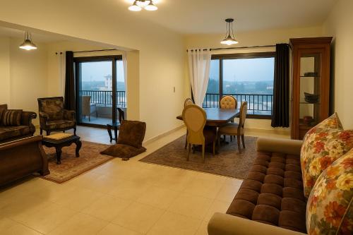 a living room with a couch and a table and chairs at The park View in Alexandria