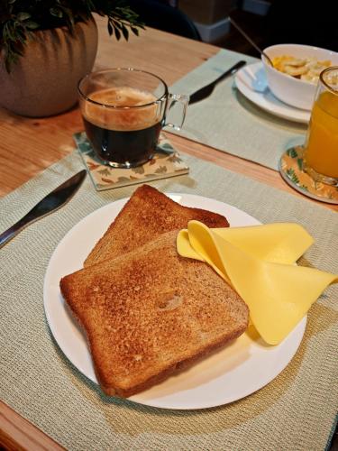 a plate of toast on a table with a cup of coffee at La Banda Suites in Seville