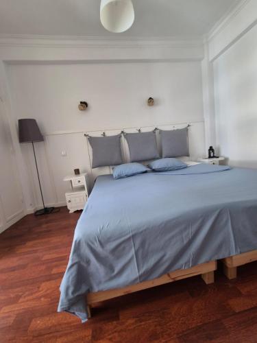 a bedroom with a large bed with blue pillows at Monteiro Duplex Terrace in Serradas
