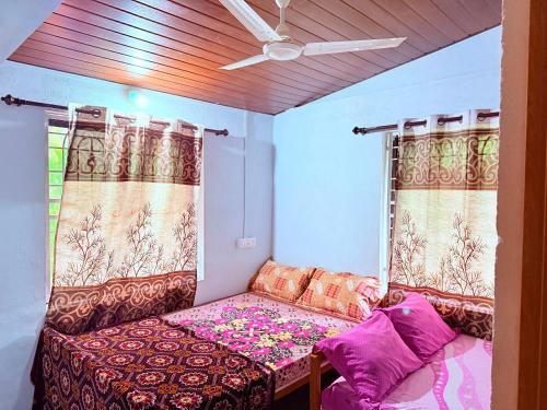 a small room with a couch and a window at Braganza Home Stay honnavar in Honāvar
