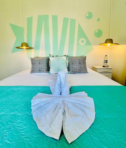 a bed with two teddy bears on top of it at Beach House Koko Apartment in Grand-Baie