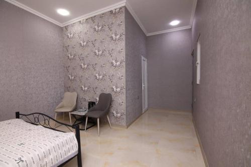 a bedroom with a bed and a table and chairs at Art House in Sevan