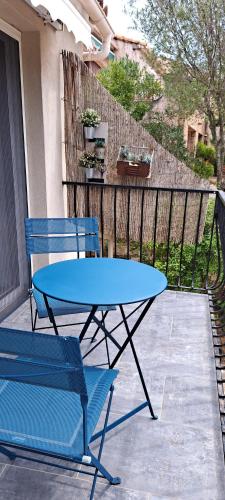 a blue table and a blue chair on a patio at Edith et Jean-Paul in Porto-Vecchio