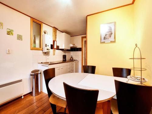 a kitchen and dining room with a table and chairs at Rustic Farm Stay in Rogery in Gouvy