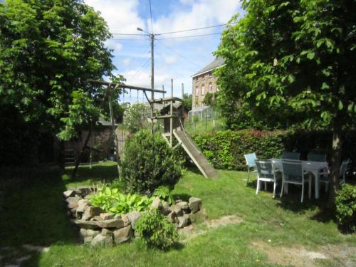 a playground with a slide in a yard at Rustic Farm Stay in Rogery in Gouvy