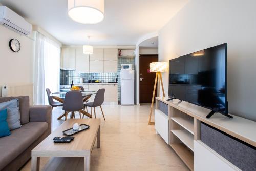 a living room with a large flat screen tv at Lis153 by Smart Cozy Suites - Top Floors with Amazing City View - Available 24hr in Athens