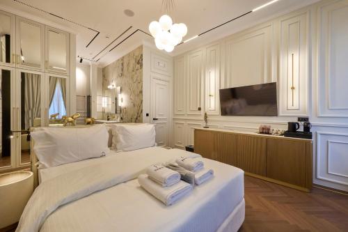 a bedroom with a large bed with towels on it at Ermou 99 Intelligent Private Suites in Athens