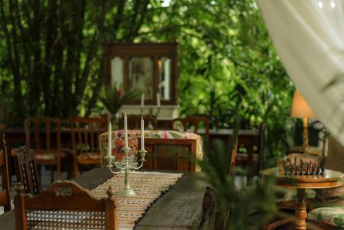 a dining room table with candles on top of it at Colina Secreta - Glamping and Villas in Puerto Viejo