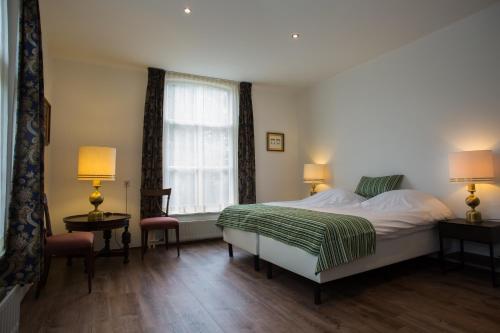 Postel nebo postele na pokoji v ubytování Landhotel De Hoofdige Boer
