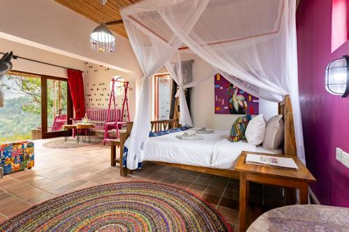 a bedroom with a bed with a canopy at Chameleon Hill Forest Lodge in Bwindi