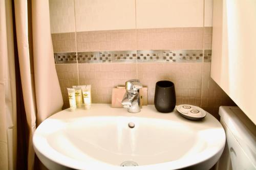a white sink in a bathroom with at Lis153 by Smart Cozy Suites - Top Floors with Amazing City View - Available 24hr in Athens
