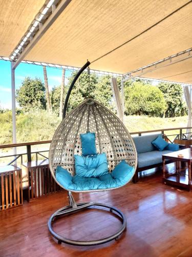 a swinging chair in a living room at Fatima Dahabiya in Luxor